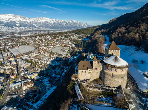 Aerial view of Vaduz Castle overlooking the snow-covered town of Vaduz and the surrounding alpine landscape in Vaduz, Vaduz, Liechtenstein.