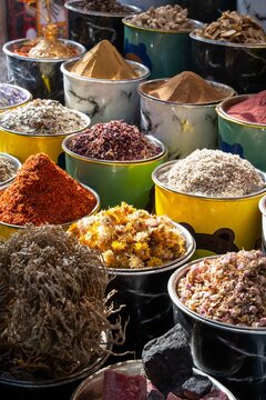 Dubai, Dubai, United Arab Emirates - 20 April 2024: View of colorful spices and dried herbs displayed in metal bowls at a traditional market.