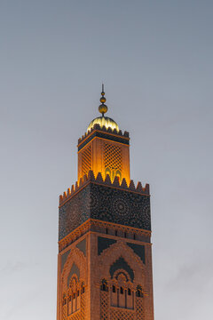 Casablanca, Casablanca-Settat, Morocco - 15 November 2025: View of the illuminated minaret of the Hassan II Mosque featuring intricate geometric tile work and traditional Moroccan architecture.