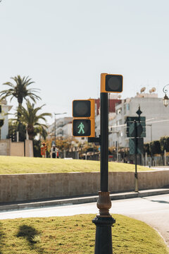 Rabat, Morocco - 14 November 2025: View of a pedestrian traffic light showing a green walking figure on a sunny day in the city.