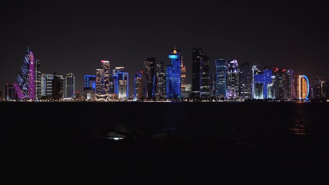View of the illuminated Doha skyline at night in Qatar.