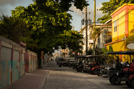 Golf carts parked on a street in San Pedro on Ambergris Caye in Belize, Central America.