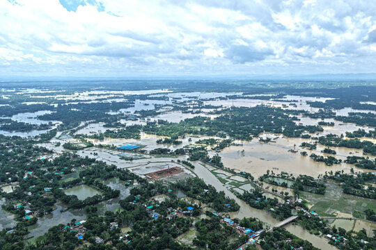 Banshkhali Upazila, Bangladesh - 14 July 2026: Aerial view of flooded landscape in Banshkhali Upazila with submerged fields, scattered houses, and overflowing waterways under a cloudy sky.