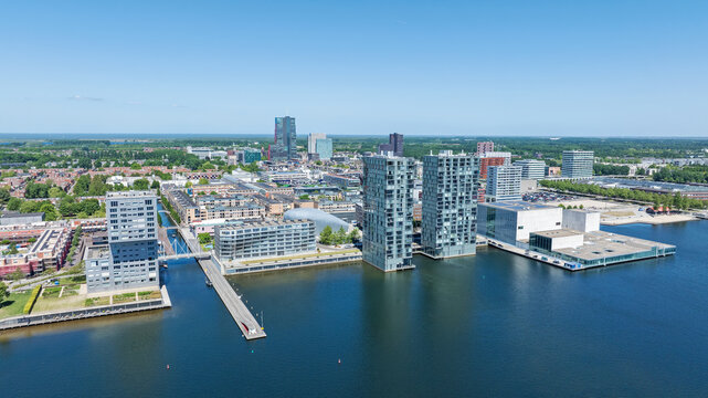 Aerial view of modern high-rise residential buildings and the Kunstlinie cultural center along the Weerwater lake in Almere, Flevoland, Netherlands.