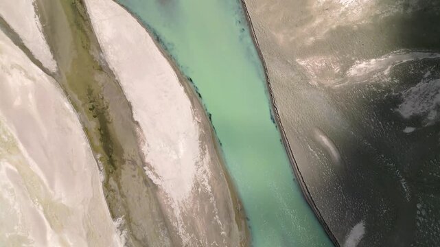 Aerial view of the turquoise Indus River flowing through the arid landscape near Dungti, Ladakh, India.