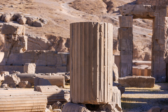Ancient broken stone column at Persepolis, Iran. Ruins of Apadana Palace. Archaeological remains of the Achaemenid Empire. UNESCO World Heritage Site.