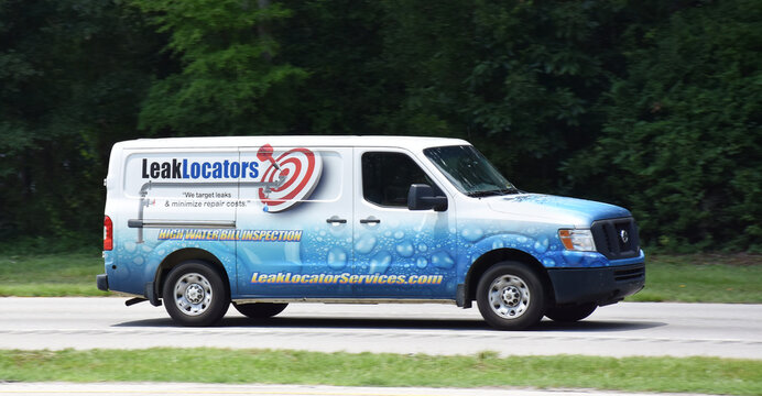 Van with Leak Locators sign, North Carolina, USA