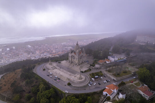 Aerial view of the Sanctuary of the Sacred Heart of Jesus on a hill overlooking the city and coastline, surrounded by misty trees in Viana do Castelo, Viana do Castelo Dist, Portugal.