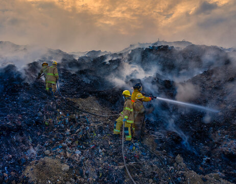 Aerial view of firefighters battling a large fire at the Vertedero Duquesa landfill with thick smoke rising into the sky in Pantoja, Santo Domingo, Dominican Republic.