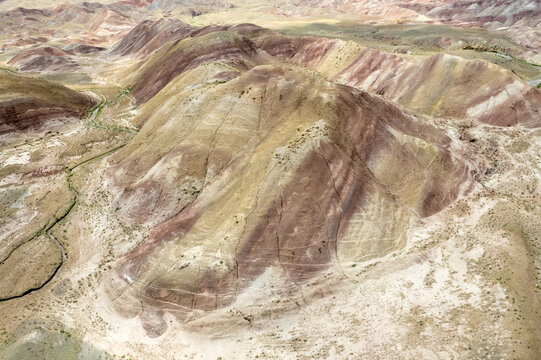 Tuzluca, Turkiye - 04 July 2025: Aerial view of the colorful Rainbow Hills, showcasing unique geological formations with layered red, yellow, and brown soil textures.