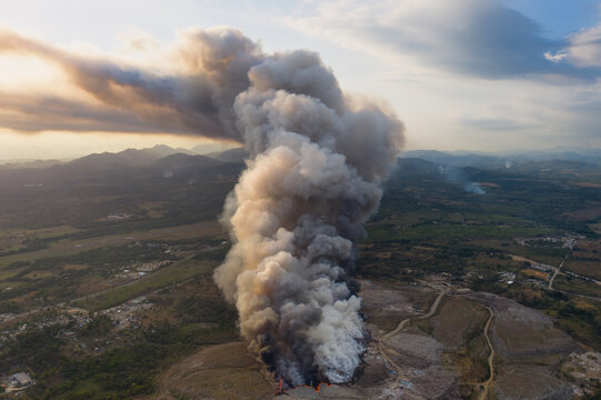 Aerial view of Vertedero duquesa landfill fire with thick smoke rising into the sky over the landscape in Pantoja, Santo Domingo, Dominican Republic.