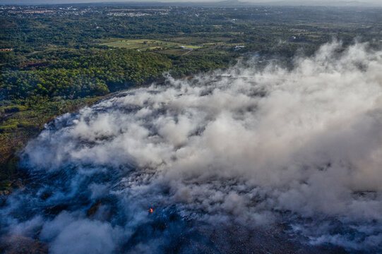 Aerial view of the fire at the Vertedero Duquesa landfill with thick smoke billowing over the surrounding landscape in Pantoja, Santo Domingo, Dominican Republic.
