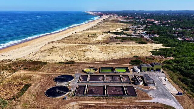 Aerial view of wastewater treatment plant near the sandy coastline of Plage des Oceanides in Capbreton, Nouvelle-Aquitaine, France.