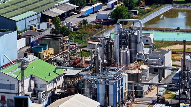 Aerial view of industrial facility with metal pipes and storage tanks at the Port of Bordeaux in Bassens, Nouvelle-Aquitaine, France.
