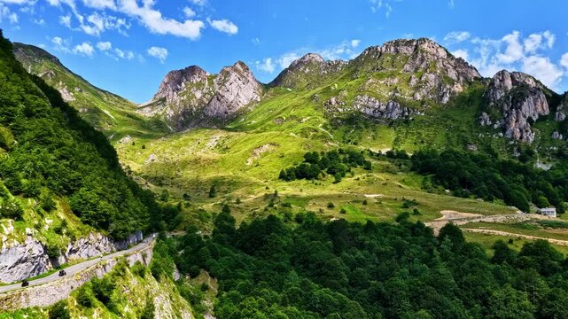Aerial view of the winding road and lush green slopes of Col d'Aubisque in the Pyrenees mountains near Beost, Nouvelle-Aquitaine, France.
