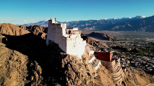 Aerial view of the historic Leh Palace perched on a rocky ridge overlooking the town of Leh, Ladakh, India.