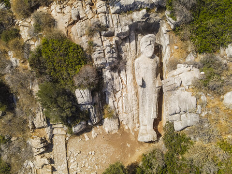 Aerial view of the ancient unfinished Kouros of Apollonas statue carved into the rocky hillside on the island of Naxos, Greece.