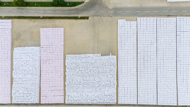 Aerial view of large stacks of white industrial bags arranged in a logistics yard in Novi Sad, Vojvodina, Serbia.