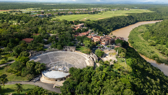 Aerial view of the historic Altos De Chavon amphitheater nestled in lush greenery overlooking the winding Chavon River in La Romana, La Romana Province, Dominican Republic.