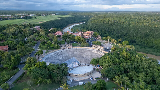 Aerial view of the historic Altos de Chavon amphitheater nestled within lush tropical forest and overlooking the Chavon River in La Romana, La Romana Province, Dominican Republic.