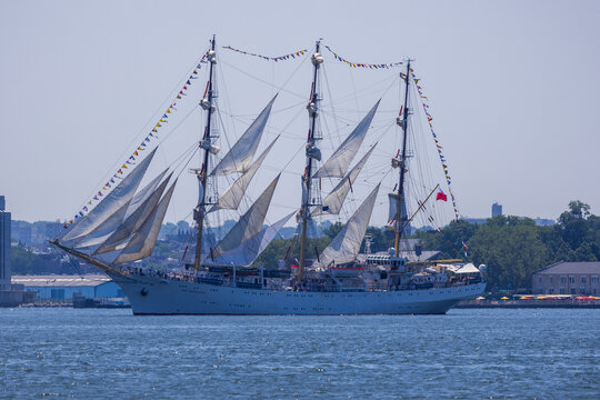 Jersey City, New Jersey, United States - 04 July 2026: View of the Chilean Navy tall ship Esmeralda sailing past Liberty State Park with white sails unfurled under a clear blue sky.