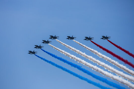 Jersey City, New Jersey, United States - 04 July 2026: View of fighter jets in formation performing an aerobatic flyover with red, white, and blue smoke trails at Liberty State Park.