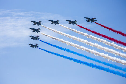 Jersey City, New Jersey, United States - 04 July 2026: View of fighter jets in formation with red, white, and blue smoke trails against a clear blue sky over Liberty State Park.