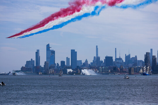 Jersey City, New Jersey, United States - 04 July 2026: View of Liberty State Park with red, white, and blue smoke trails from an air show over the Manhattan skyline.