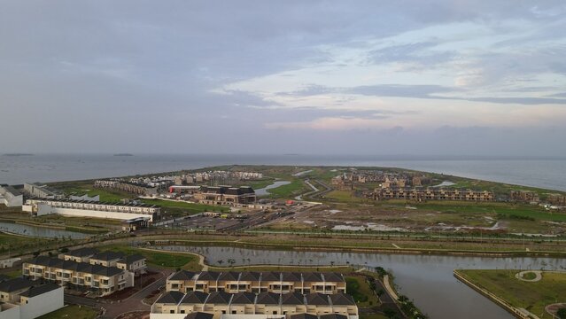 Aerial view of Golf Island residential development in Pantai Indah Kapuk, featuring modern housing, canals, and coastal scenery, Kecamatan Penjaringan, Daerah Khusus Ibukota, Indonesia.