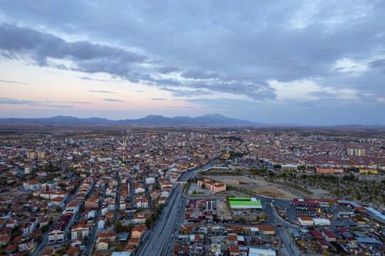Karaman, Turkiye - 22 October 2025: Aerial view of the city of Karaman with its dense urban landscape, residential rooftops, and distant mountains under a cloudy sky.