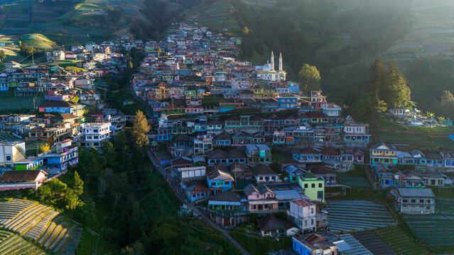 Kecamatan Kaliangkrik, Jawa Tengah, Indonesia - 15 July 2026: Aerial view of Nepal Van Java, a colorful village on the slopes of Mount Sumbing with terraced fields and a mosque.