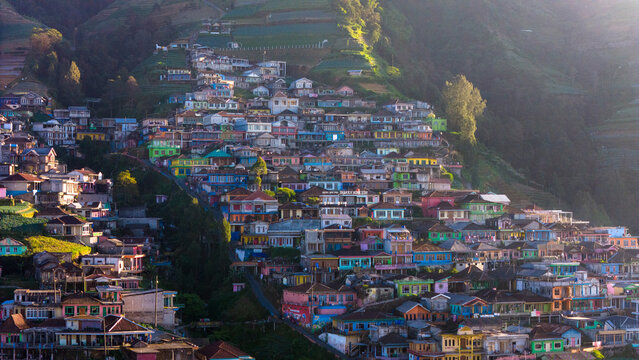 Aerial view of Nepal Van Java featuring colorful houses built on the steep terraced slopes of the hillside in Kecamatan Kaliangkrik, Jawa Tengah, Indonesia.