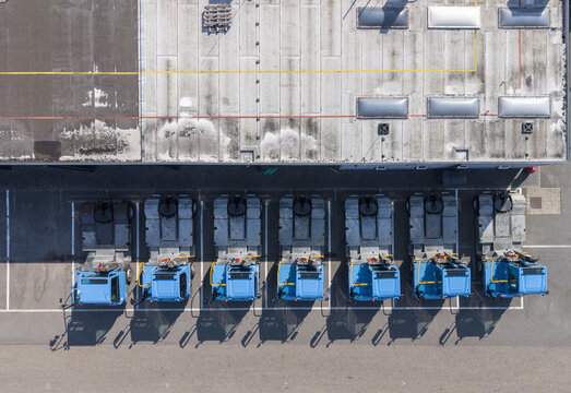 Aerial view of Scania Production Zwolle showing a row of blue truck cabs parked in the factory lot in Zwolle, Overijssel, Netherlands.