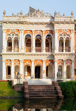 Sonargaon, Dhaka Division, Bangladesh - 19 November 2025: View of the ornate facade of a historic building in Panam Nagar, with intricate carvings, arched windows, and stone statues.