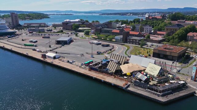 Aerial view of the SALT art project featuring wooden structures and tents along the waterfront in Oslo, Oslo, Norway.