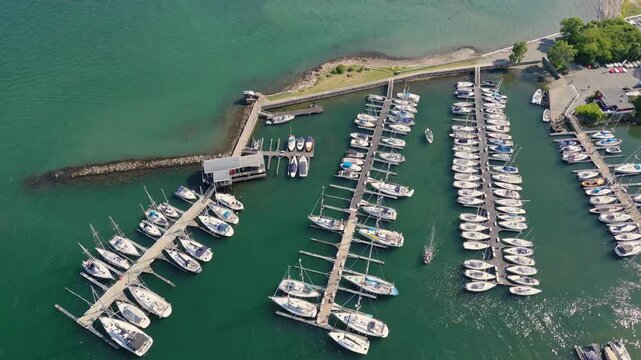 Aerial view of Bygdoy marina with rows of sailboats docked at wooden piers in the turquoise waters of Oslo, Oslo, Norway.