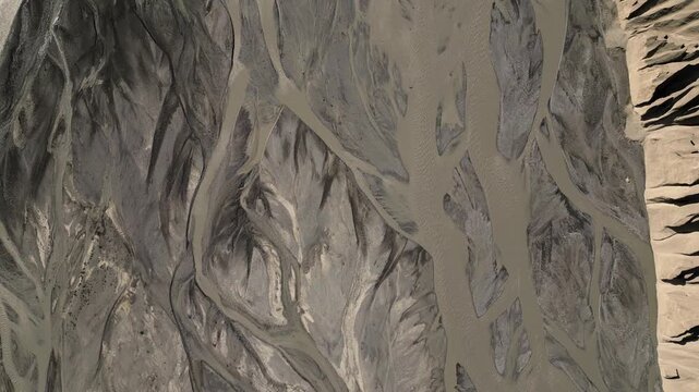 Aerial view of braided river channels flowing through the arid landscape of the Spiti Valley in Lahaul and Spiti, Himachal Pradesh, India.