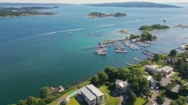 Aerial view of Bygdoy peninsula featuring the marina, lush green trees, and coastal waters in Oslo, Oslo, Norway.
