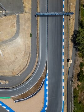 Alcabideche, Portugal - 16 July 2026: Aerial view of the Autodromo Fernanda Pires da Silva racetrack, showing the asphalt track, blue and white curbing, and surrounding dry landscape.