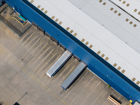 Aerial view of commercial distribution center with loading docks and parked trailers at Magna Park, England, United Kingdom.