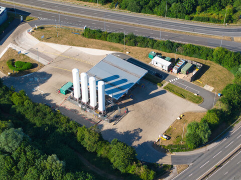Aerial view of the Gasrec Bio-LNG refueling facility with white storage tanks and canopy located near the highway in Kilsby, England, United Kingdom.