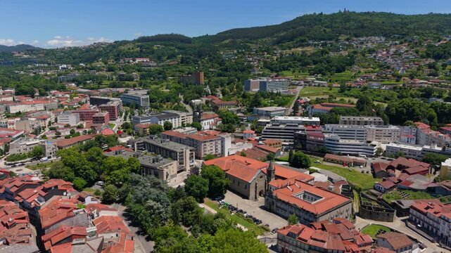 Aerial view of the historic Church of Saint Francis surrounded by traditional red-tiled rooftops and urban architecture in Guimaraes, Braga, Portugal.