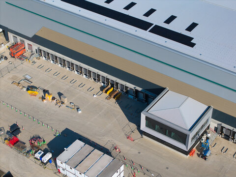 Aerial view of the Daventry International Rail Freight Terminal featuring large warehouse loading bays and industrial logistics infrastructure in Kilsby, England, United Kingdom.