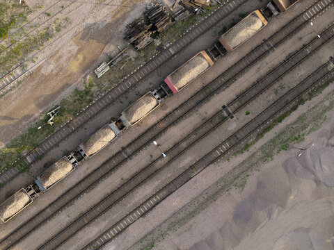 Aerial view of a freight train loaded with stone aggregate moving along tracks at a stone mine in Zalas, Lesser Poland Voivode, Poland.