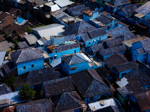 Aerial view of Kampung Warna Warni Jodipan showing the vibrant blue painted rooftops and dense urban housing in Kecamatan Blimbing, Jawa Timur, Indonesia.