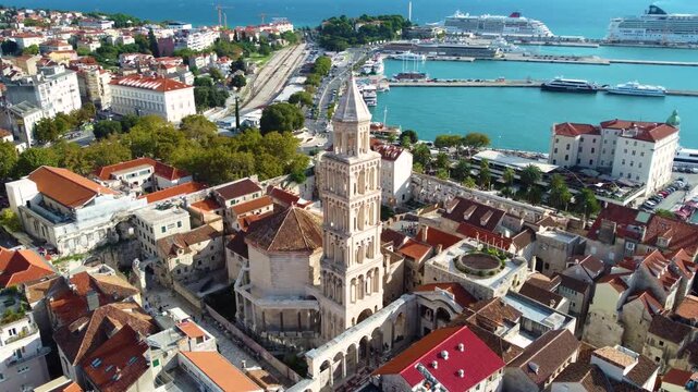 Aerial view of Saint Domnius Cathedral surrounded by historic terracotta rooftops and the Adriatic Sea in Split, Splitsko-dalmatinska, Croatia.