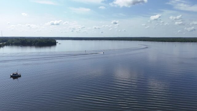 Boats cruising on a calm Summer day in the St Johns River near downtown Palatka in Putnam County, Florida. 