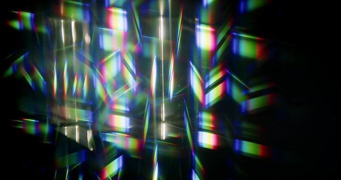 Light ray shining through a prism for angled beams of sparkling shine in brilliant colors. Swirling reflective glass with beaming lights creating visual effect of a brilliant dazzling rainbow.