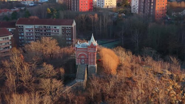 Aerial view of the historical old water tower surrounded by trees and residential buildings in Gothenburg, Vastra Gotaland Count, Sweden.