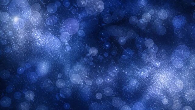 Abstract blue bokeh light background with glowing circular patterns